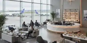 Modern airport lounge with travelers relaxing and enjoying amenities before a flight.