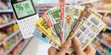 Hands holding a stack of coupons with a calculator and shopping cart, symbolizing maximum savings.